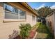 A well-maintained side yard features a healthy garden, beige siding, and a chain link fence at 4807 Wynwood Dr, Tampa, FL 33615