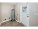 Utility room featuring water heater and an exterior door at 4807 Wynwood Dr, Tampa, FL 33615