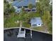 Aerial view of home with lush backyard, pool house, and private boat dock at 58 Inness Dr, Tarpon Springs, FL 34689