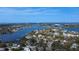 Wide aerial shot of a waterfront community featuring canal access to the open ocean at 58 Inness Dr, Tarpon Springs, FL 34689