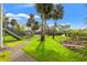 Backyard view of canal, covered area, dock, and lush landscaping from the yard at 58 Inness Dr, Tarpon Springs, FL 34689