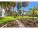 Backyard view of canal, covered area, dock, and lush landscaping from the yard at 58 Inness Dr, Tarpon Springs, FL 34689