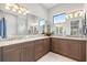 Bathroom featuring double vanity, granite countertops, and a large mirror for a luxurious feel at 58 Inness Dr, Tarpon Springs, FL 34689