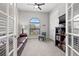 Cozy bedroom with plush carpet, a ceiling fan, and an arched window bringing in natural light at 58 Inness Dr, Tarpon Springs, FL 34689