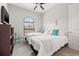 Bright bedroom with two twin beds, a large window, and calming decor creates a serene space at 58 Inness Dr, Tarpon Springs, FL 34689