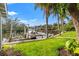 Tranquil waterfront dock with seating, canopy and grassy yard at 58 Inness Dr, Tarpon Springs, FL 34689