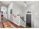 Elegant hallway featuring dark hardwood floors, neutral walls and decorative rug leading to the home's entry at 58 Inness Dr, Tarpon Springs, FL 34689