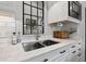 Close-up of the kitchen sink featuring a gooseneck faucet and white countertops at 58 Inness Dr, Tarpon Springs, FL 34689