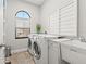 Well-lit laundry room featuring modern washer and dryer, sink and ample counter space at 58 Inness Dr, Tarpon Springs, FL 34689