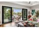 Living room featuring sliding glass doors to the outdoor patio, comfortable seating, and stylish decor at 58 Inness Dr, Tarpon Springs, FL 34689