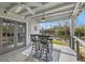 Pool house interior featuring a bar, tile floors, and outdoor water views at 58 Inness Dr, Tarpon Springs, FL 34689