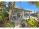 Charming pool house with patio seating and scenic water views at 58 Inness Dr, Tarpon Springs, FL 34689