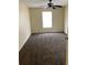 This bedroom features carpet, neutral walls, a ceiling fan, and a double-hung window at 5924 Brickleberry Ln # 101, Zephyrhills, FL 33541