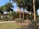 Community clubhouse exterior view with palm trees and beautiful landscaping at 5924 Brickleberry Ln # 101, Zephyrhills, FL 33541