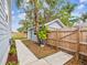 View of the backyard shed with lovely landscaping and a wooden fence at 605 12Th N Ave, St Petersburg, FL 33701