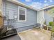 Cozy backyard patio with grill, exterior door, and a well-kept blue facade at 605 12Th N Ave, St Petersburg, FL 33701