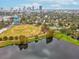 Aerial view of a baseball field next to a lake, with cityscape views and surrounding greenery and trees at 605 12Th N Ave, St Petersburg, FL 33701