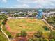 Aerial view of a well-maintained baseball field with a water tower, surrounded by trees and residential areas at 605 12Th N Ave, St Petersburg, FL 33701