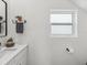 Bathroom featuring a white vanity with a sink, a mirror, and a window at 605 12Th N Ave, St Petersburg, FL 33701