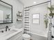 Renovated bathroom featuring subway tile, black hardware, and quartz countertop at 605 12Th N Ave, St Petersburg, FL 33701