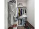 A closet with hanging clothes and storage shelves for organization at 605 12Th N Ave, St Petersburg, FL 33701