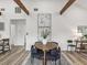 Bright dining area highlighting wooden beams, luxury vinyl plank flooring, and modern decor at 605 12Th N Ave, St Petersburg, FL 33701