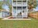 Charming two-story home with double balconies, lush lawn, and blue siding at 605 12Th N Ave, St Petersburg, FL 33701