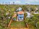 Charming two-story home with a cozy balcony, lush green lawn, and a beautifully fenced yard for privacy at 605 12Th N Ave, St Petersburg, FL 33701