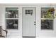 The front door is framed by windows and greenery for curb appeal, welcoming visitors to enter at 605 12Th N Ave, St Petersburg, FL 33701