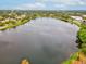 Aerial view of a serene lake surrounded by lush greenery, mature trees, and residential areas at 605 12Th N Ave, St Petersburg, FL 33701