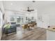 Bright living room features wood floors, a ceiling fan, and sliding doors to the outdoor area at 605 12Th N Ave, St Petersburg, FL 33701