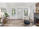 Inviting living room is bathed in natural light with luxury vinyl plank flooring and gray accent chair at 605 12Th N Ave, St Petersburg, FL 33701