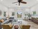 Spacious living room features neutral tones, a plush sofa, large windows, and a glass sliding door to the backyard at 605 12Th N Ave, St Petersburg, FL 33701