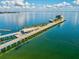 Aerial shot showcases a pier extending into the ocean, featuring modern architecture and waterfront views at 605 12Th N Ave, St Petersburg, FL 33701