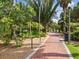 Scenic brick-paved walkway lined with vibrant greenery at a lush park in St. Petersburg, Florida at 605 12Th N Ave, St Petersburg, FL 33701