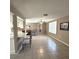 Open-concept living room featuring tile flooring, neutral walls, a ceiling fan, and shutters for plenty of natural light at 7044 Everest St, Spring Hill, FL 34606