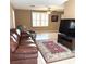 Cozy living room featuring comfortable seating, a ceiling fan, and a large television for entertainment at 7044 Everest St, Spring Hill, FL 34606