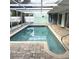 Enclosed in ground pool with clear water and patio at 7044 Everest St, Spring Hill, FL 34606