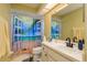 Bathroom area featuring a beach-themed shower curtain and a white vanity at 7536 Roland Ct, New Port Richey, FL 34654