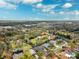 Explore the beauty of a neighborhood with verdant trees and inviting homes from a stunning aerial viewpoint at 759 Timuquana Ln, Palm Harbor, FL 34683