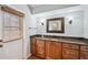 This bathroom features a beautiful vanity with granite countertop, stylish sconces, and a window at 759 Timuquana Ln, Palm Harbor, FL 34683