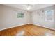 Bedroom features bright windows, wood floors, and a floral wall design at 759 Timuquana Ln, Palm Harbor, FL 34683