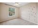 Bedroom with neutral carpet, a leaf wall design, and bright window at 759 Timuquana Ln, Palm Harbor, FL 34683