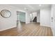 Open-concept living room featuring wood-look flooring, a staircase, and plenty of natural light, creating an airy feel at 759 Timuquana Ln, Palm Harbor, FL 34683