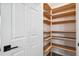 Walk-in pantry with wooden shelving providing ample storage space and organization at 759 Timuquana Ln, Palm Harbor, FL 34683