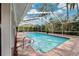 Dive into relaxation in this screened pool with brick surround, perfect for outdoor enjoyment at 759 Timuquana Ln, Palm Harbor, FL 34683