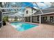 Relax in this large screened pool, complete with brick surround, for the ultimate outdoor living experience at 759 Timuquana Ln, Palm Harbor, FL 34683