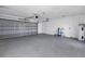 Spacious garage with gray epoxy flooring, overhead door, and a utility closet with water heater at 809 59Th Ave, St Pete Beach, FL 33706