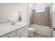 Bathroom featuring a quartz countertop vanity, framed mirror, and tiled shower-tub combination at 8363 Sandbank Pl, Englewood, FL 34224