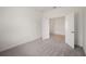 Cozy bedroom with neutral carpet, white walls, and an open doorway leading to other rooms at 8363 Sandbank Pl, Englewood, FL 34224